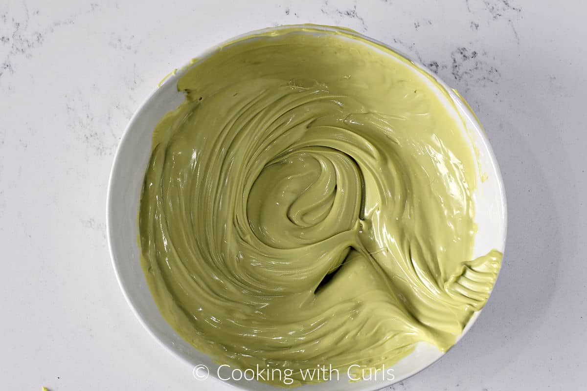 A bowl of melted green chocolate. 