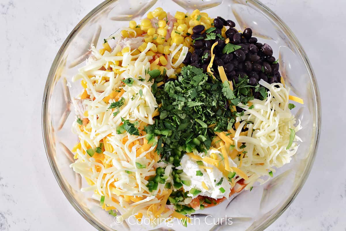 Corn, black beans, cilantro, grated cheese, chopped turkey, and diced jalapeno in a large mixing bowl. 