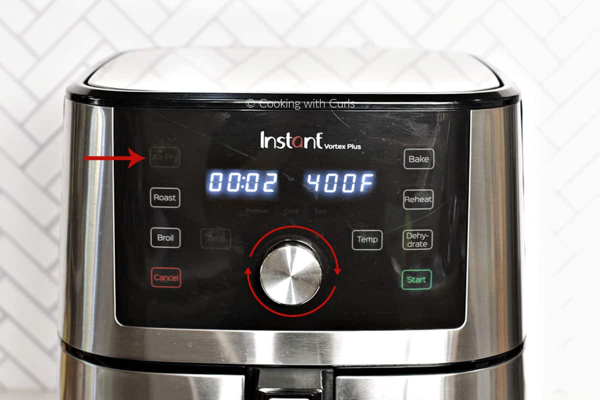 Air Fryer display set for 2 minutes at 400 degrees with an arrow pointing at the air fry button. 