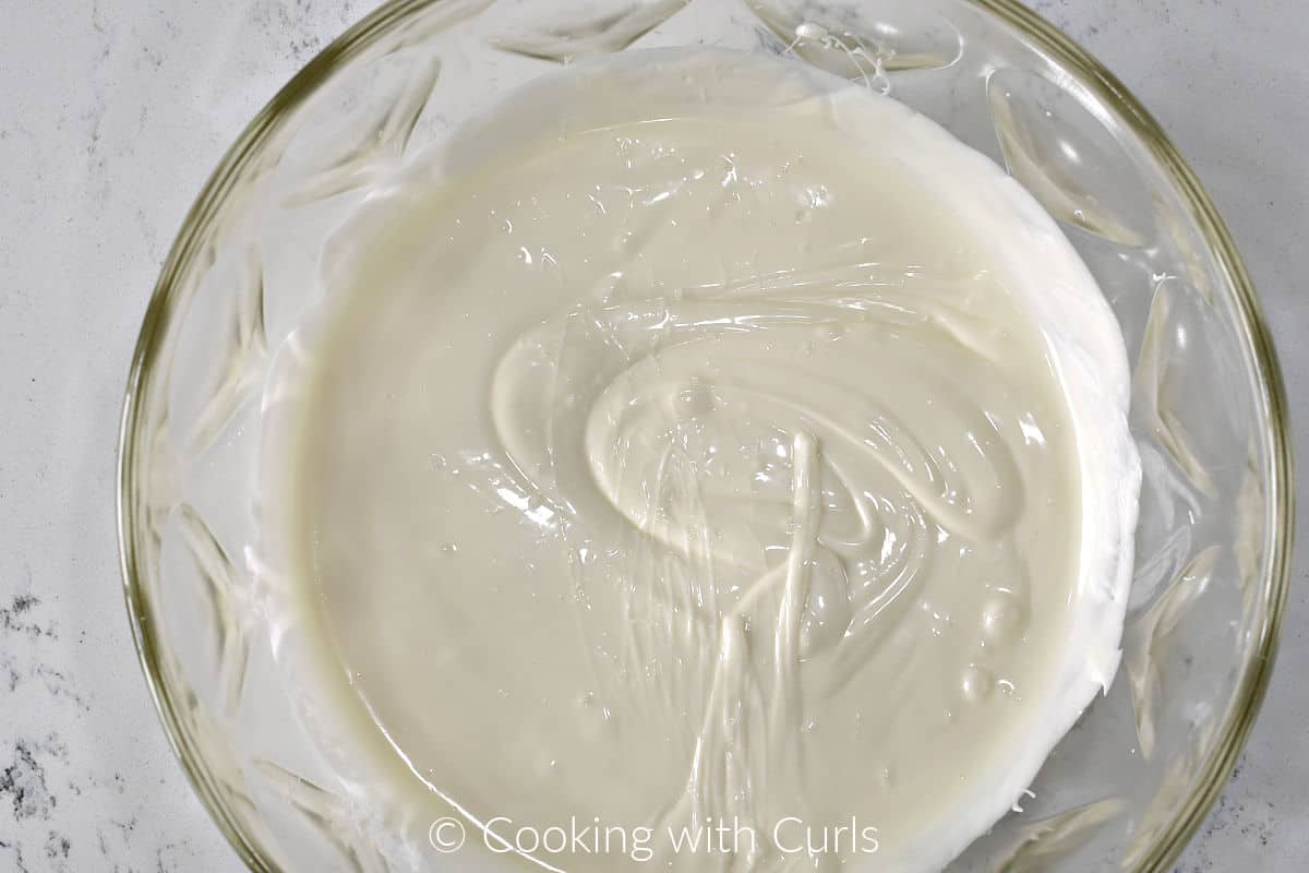 Melted white chocolate in a large mixing bowl. 