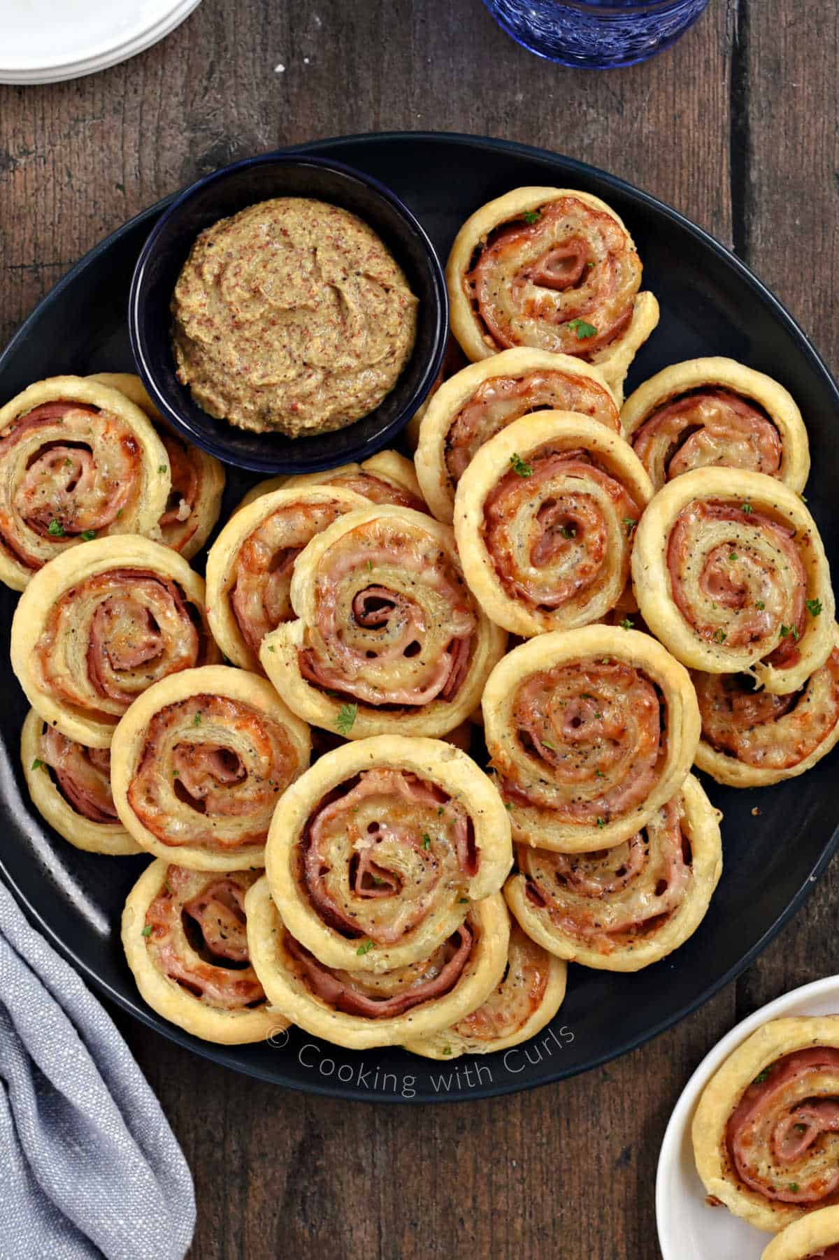 A plate of Ham and Cheese Pinwheels made with puff pastry. 
