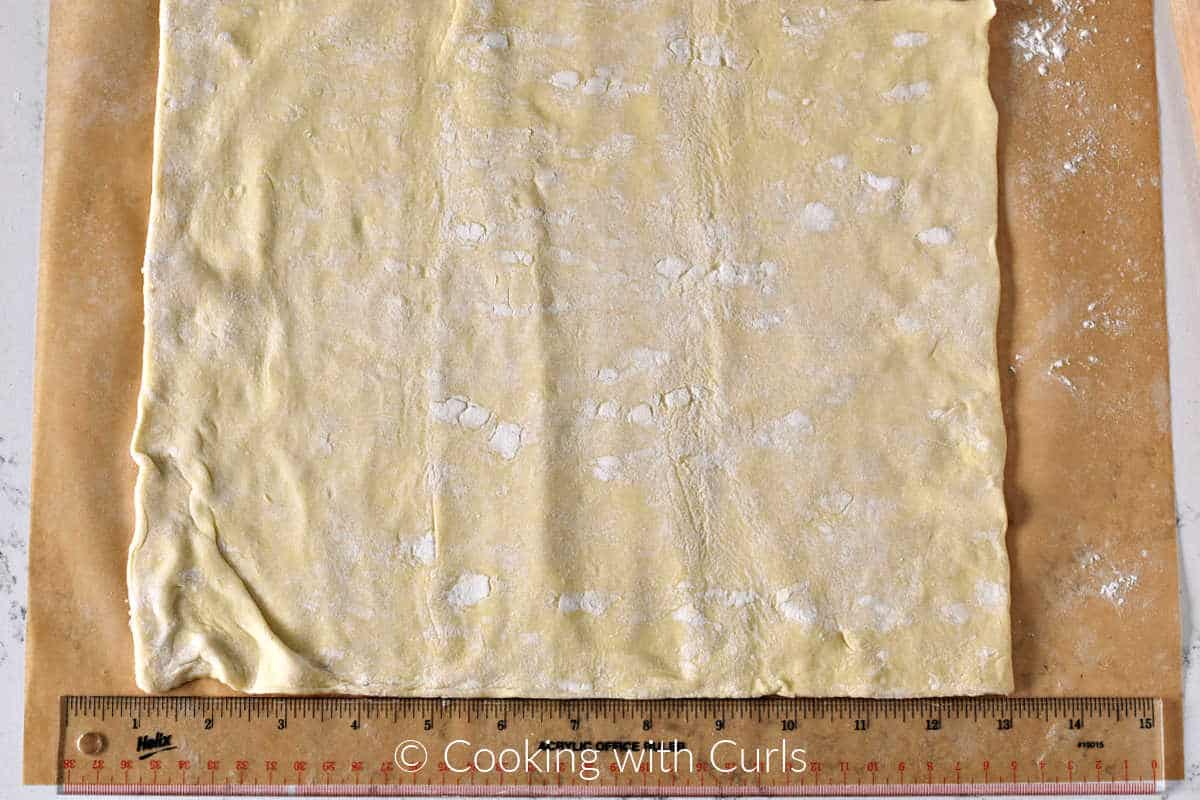 Puff-pastry-sheet-rolled-out-on-parchment-paper.