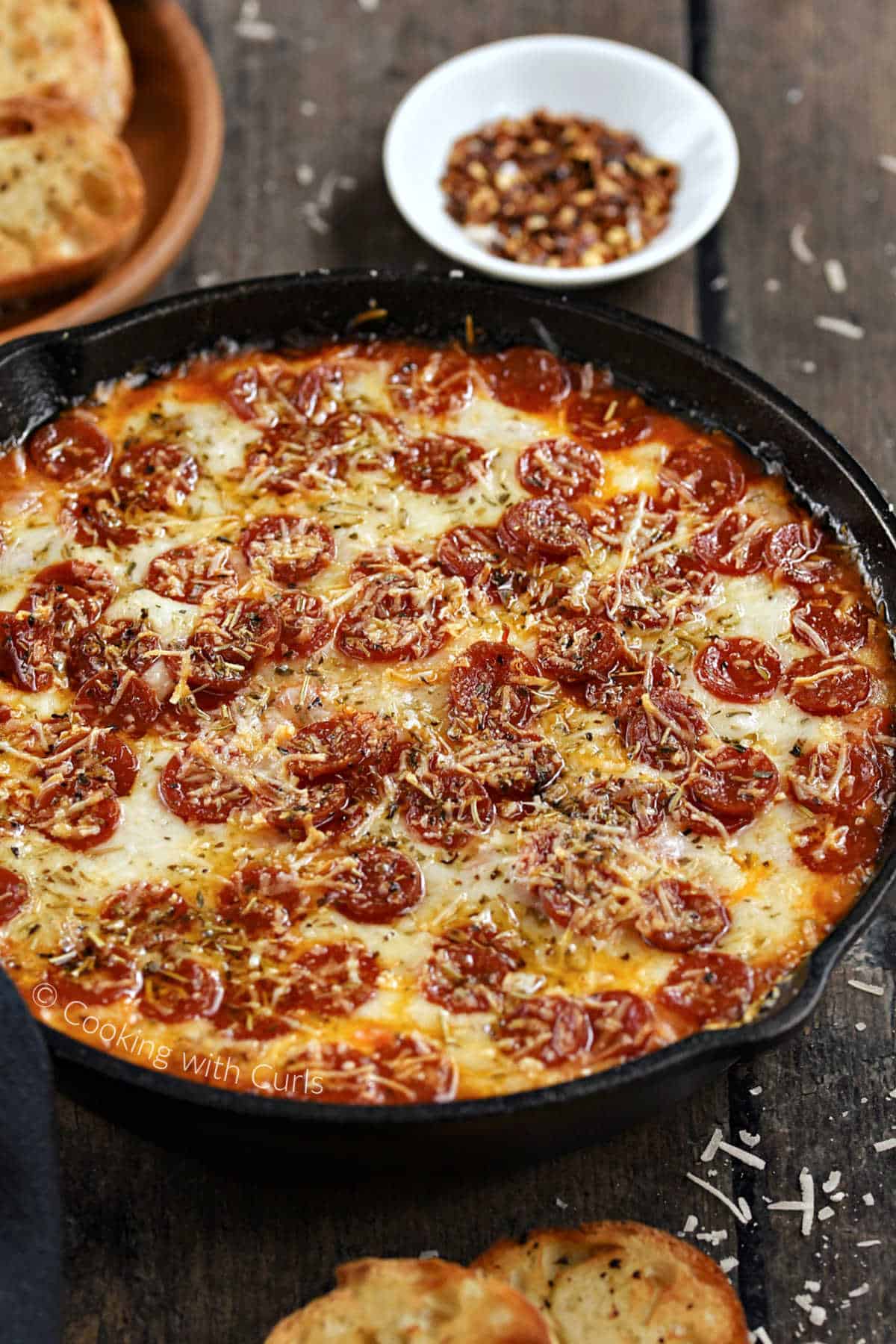 Cheesey-pizza-dip-with-mini-pepperoni-in-a-cast-iron-skillet.