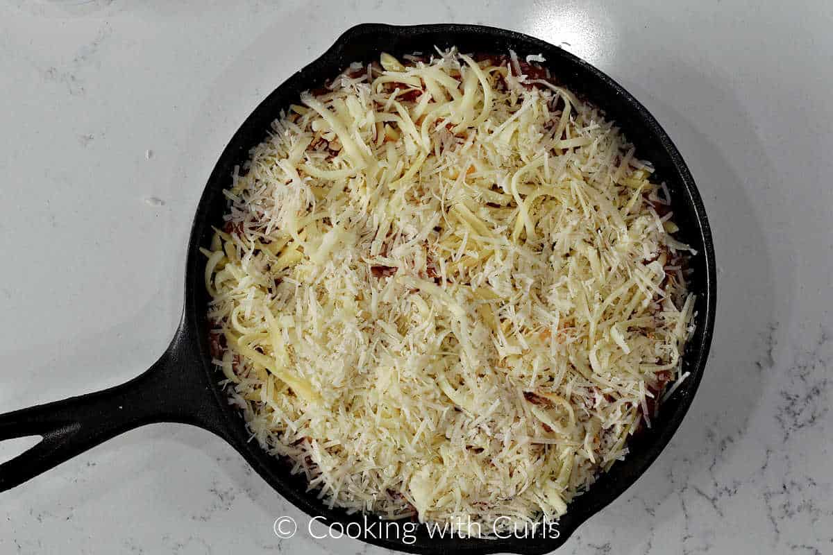 Grated-mozzarella-provolone-and-parmesan-cheese-in-a-cast-ion-skillet.