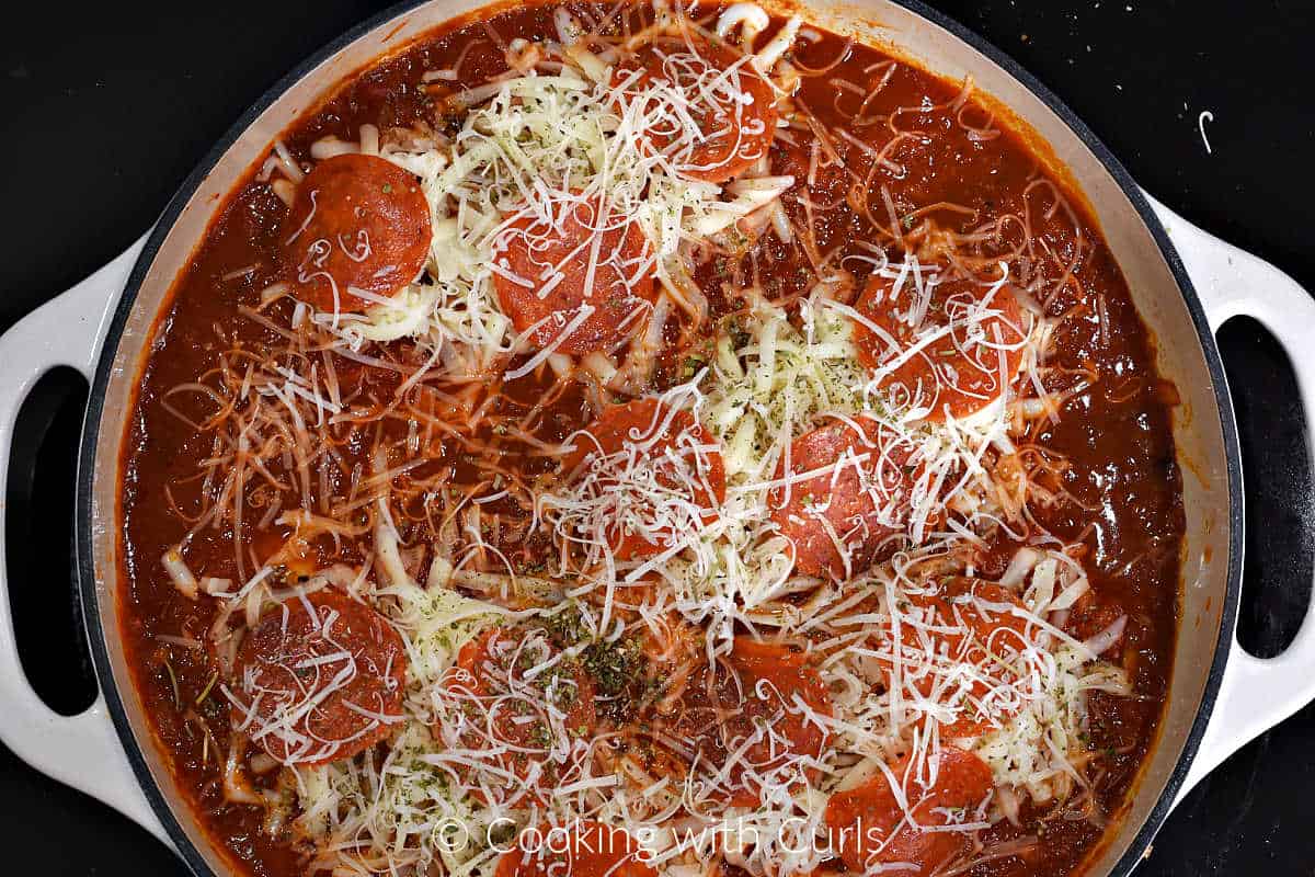 Chicken breasts, pizza sauce, pepperoni slices, and grated cheeses in a large skillet.