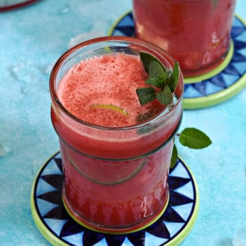 Two-glasses-of-watermelon-agua-fresca-with-lime-and-mint-sprig.