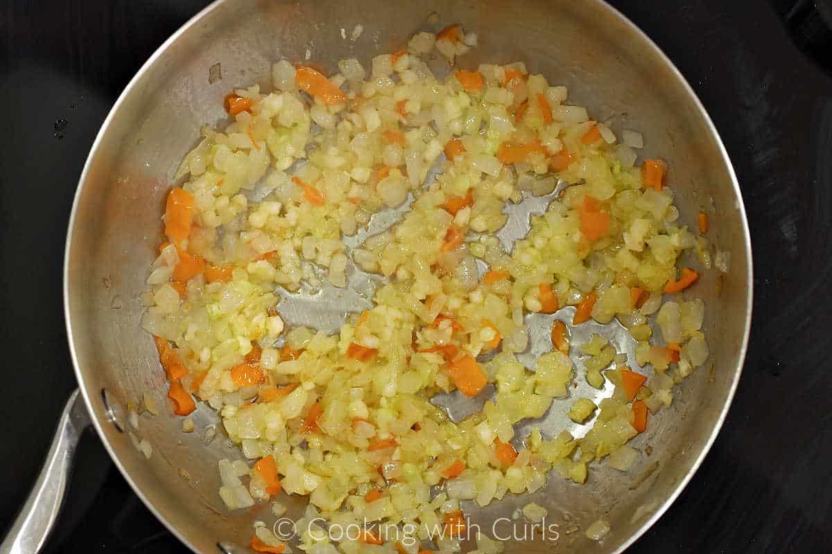 Diced onion, garlic, and habanero pepper cooked in a saucepan.
