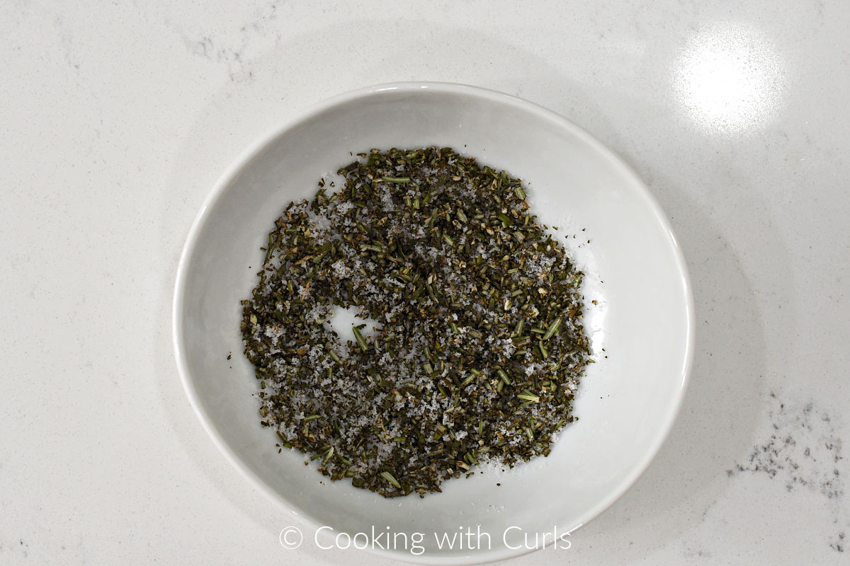 Finely chopped rosemary and sea salt mixed in a small bowl.