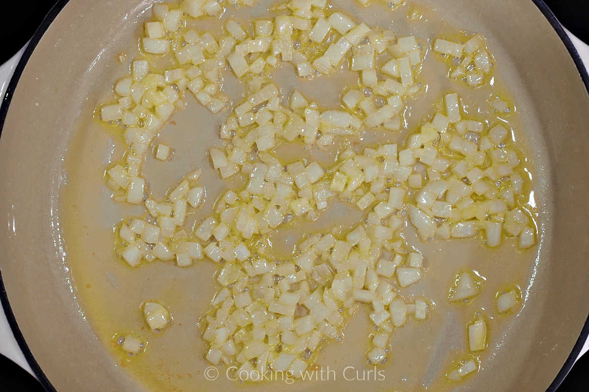 Diced onion and oil cooking in a large skillet.
