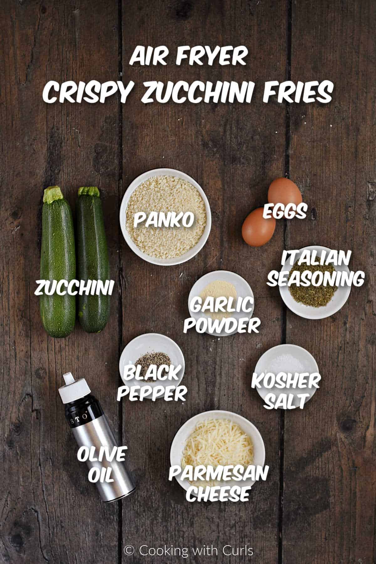 Ingredients to make crispy air fryer zucchini fries on a wood background.