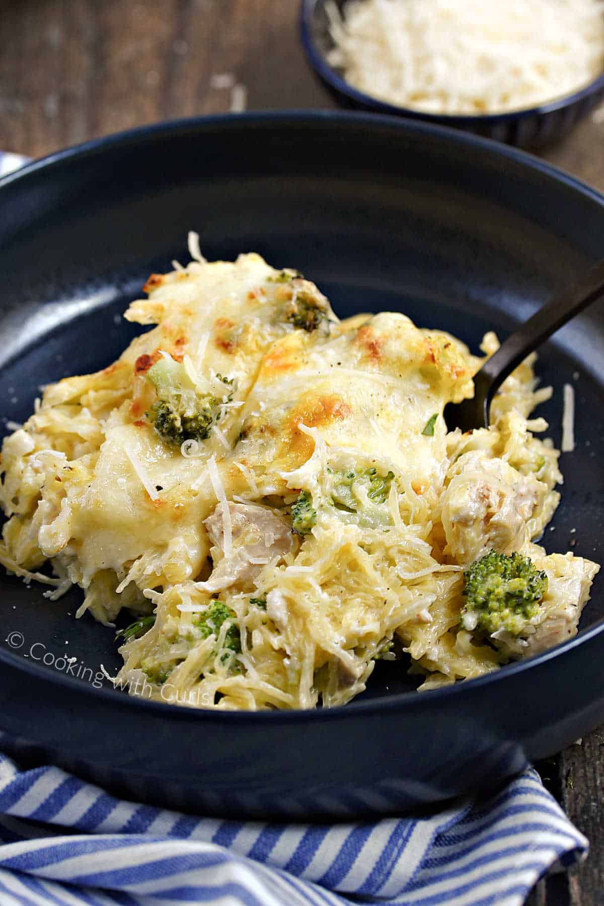 Chicken Alfredo Spaghetti Squash with broccoli and melted cheese in a bowl.