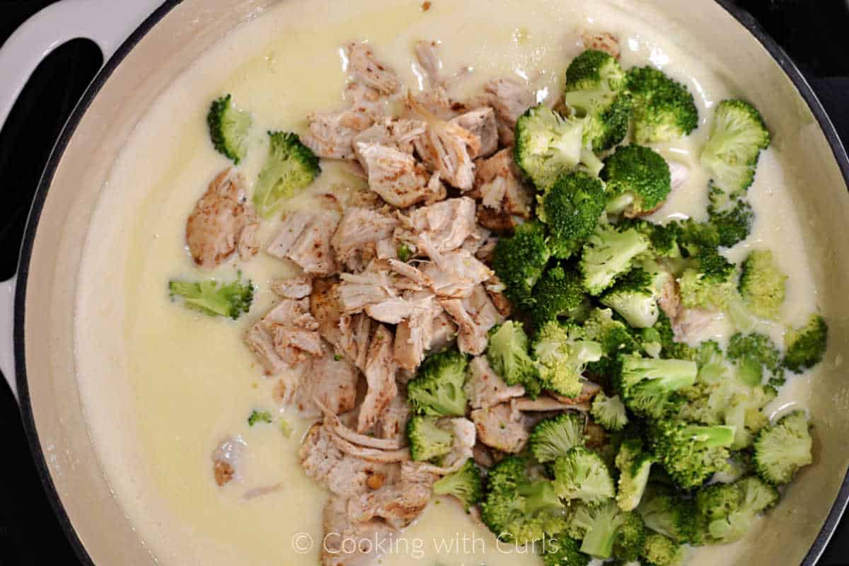 Chicken cubes and broccoli in alfredo sauce.