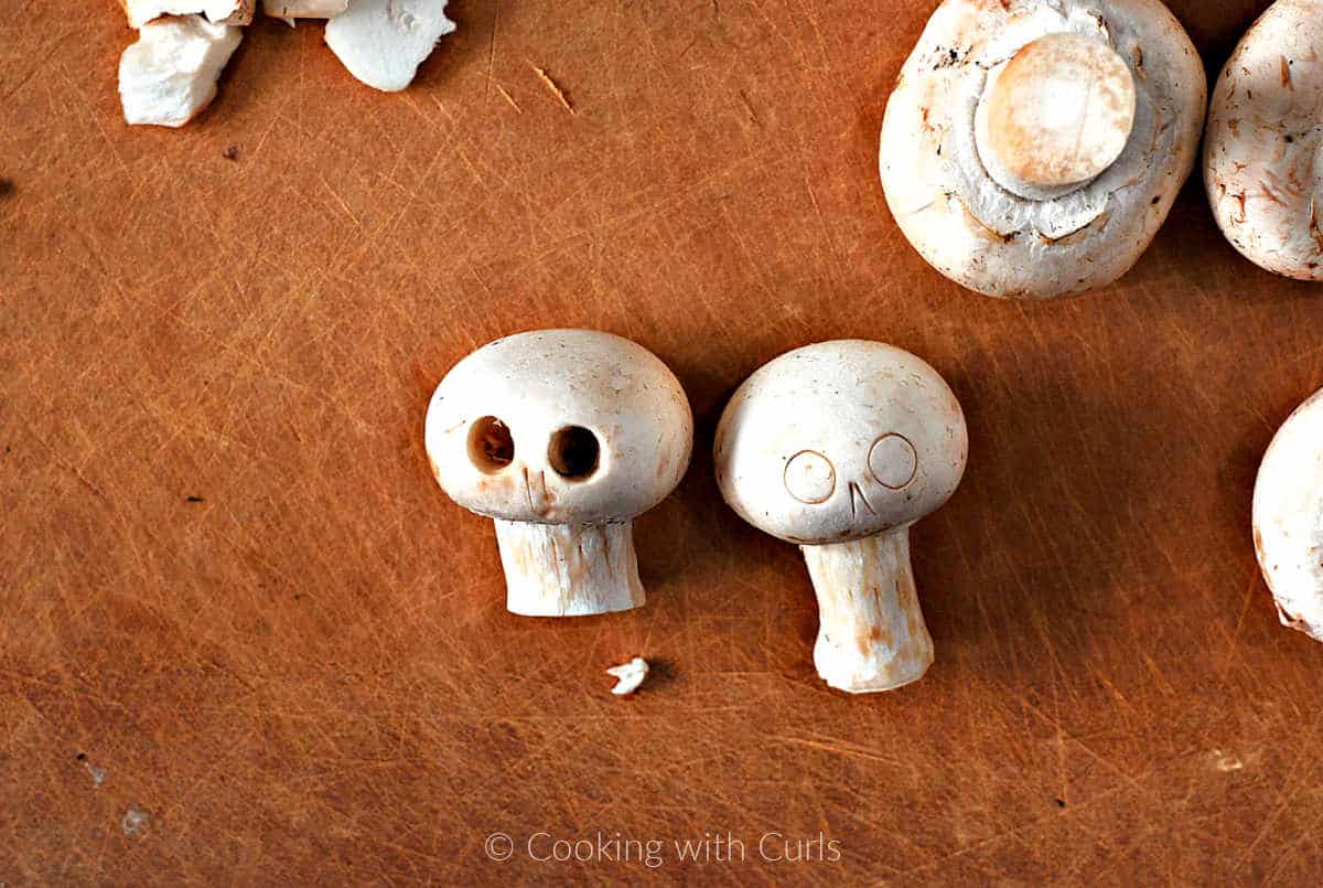 Mushrooms with eye holes cut in the center.