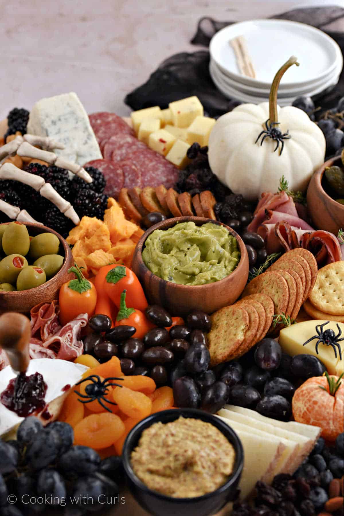Halloween charcuterie board with meats, cheeses, and other snacks.