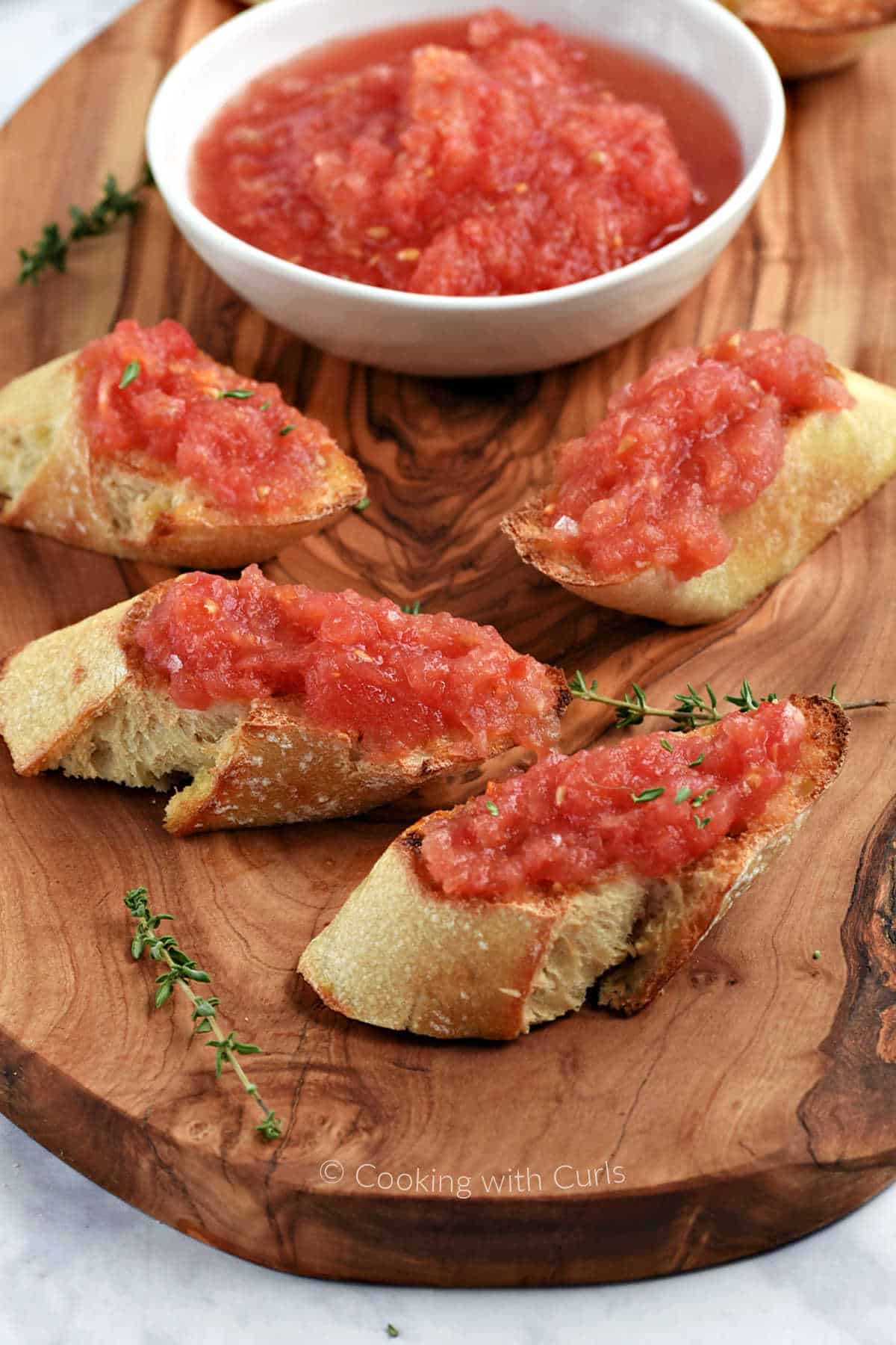 Thick toasted bread slices topped with grated fresh tomato.