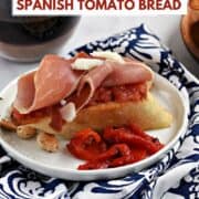 Toasted bread topped with grated ripe tomato, jamon, and manchego cheese with title graphic across the top.
