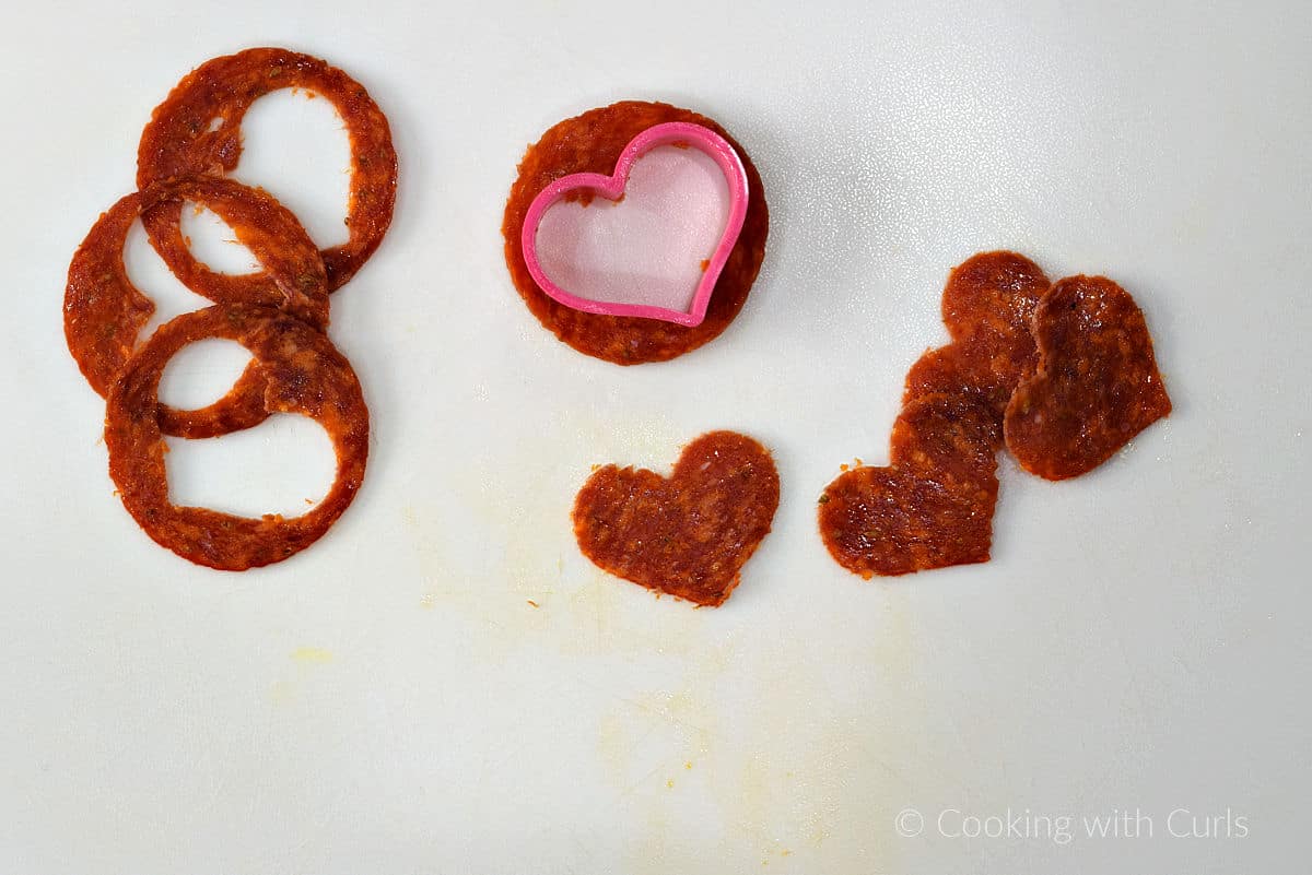 Pepperoni slices cut into heart shapes with a small cookie cutter.