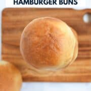 Looking down on a stack of hamburger buns on a wood board with title graphic across the top.