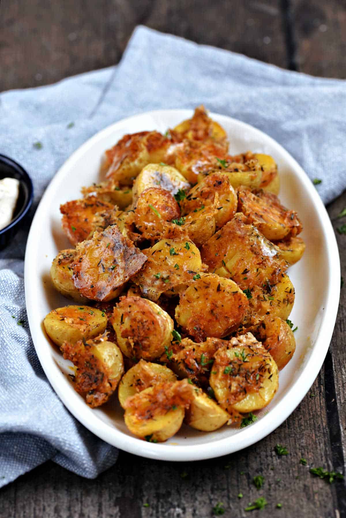Parmesan roasted potatoes on an oval serving platter.