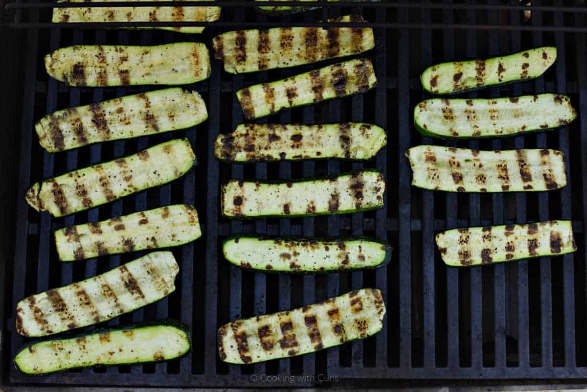 Grilled zucchini slices on a gas grill.