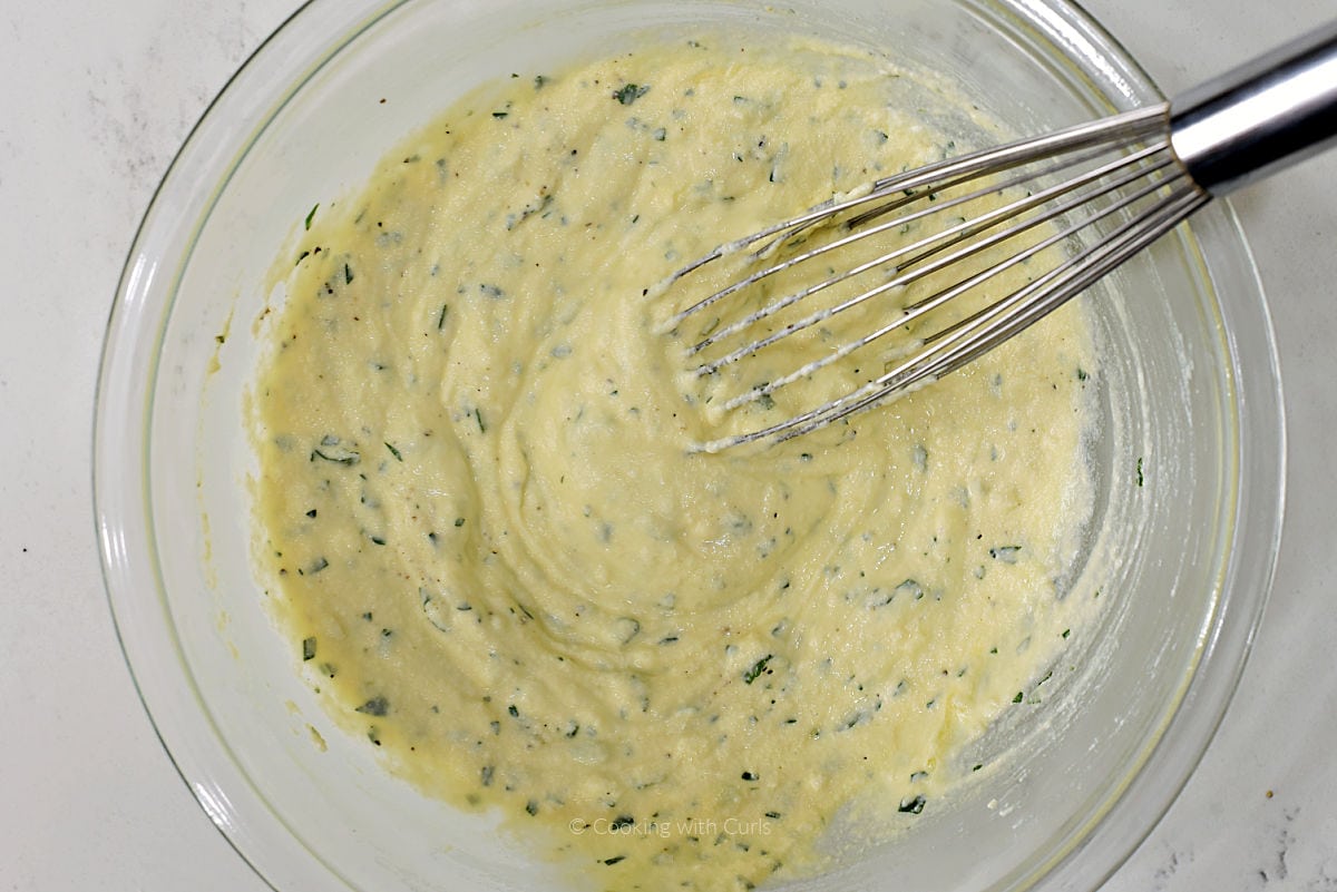 Ricotta cheese mixture in a mixing bowl.