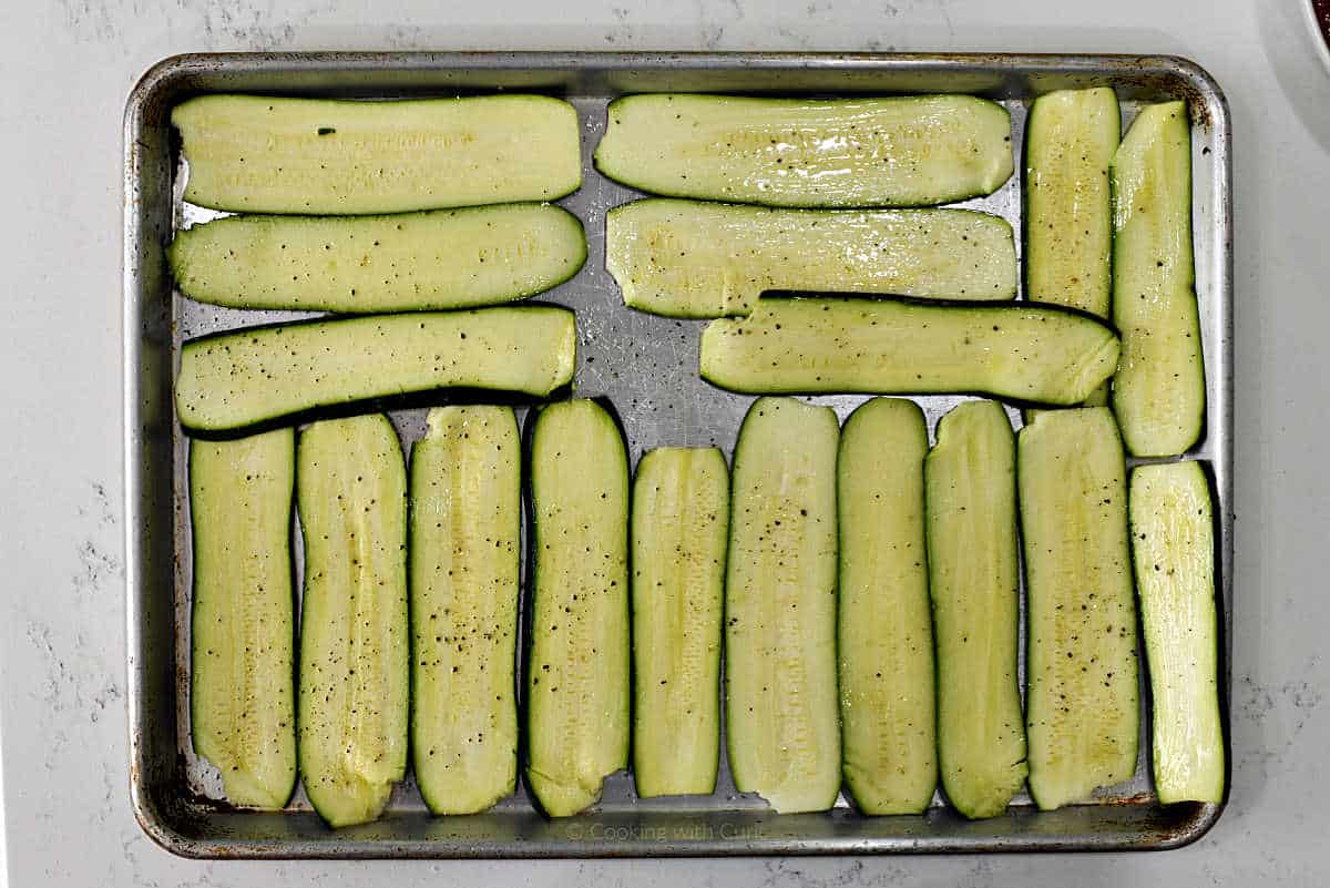 Zucchini slices on a baking sheet.