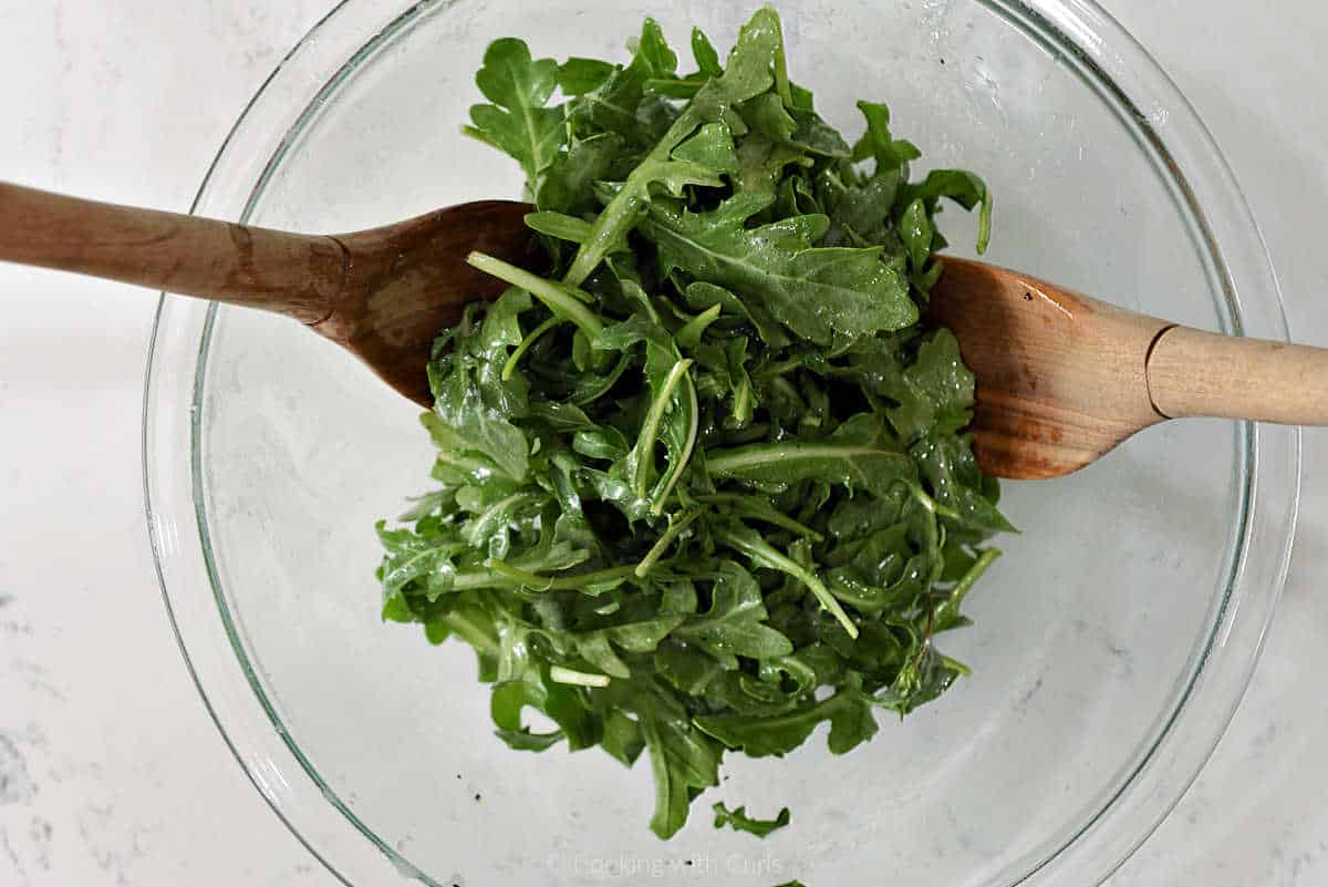 Arugula leaves tossed with lemon vinaigrette.