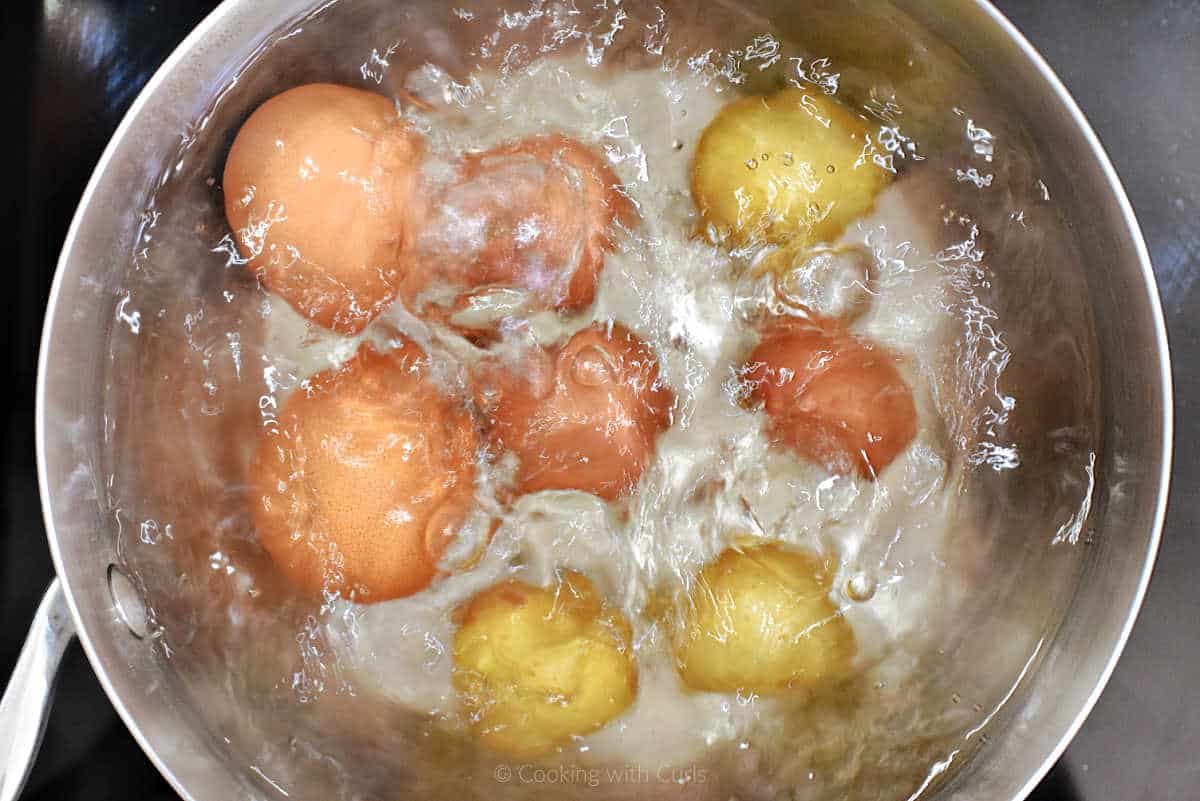 Baby potatoes and two egg in boiling water.