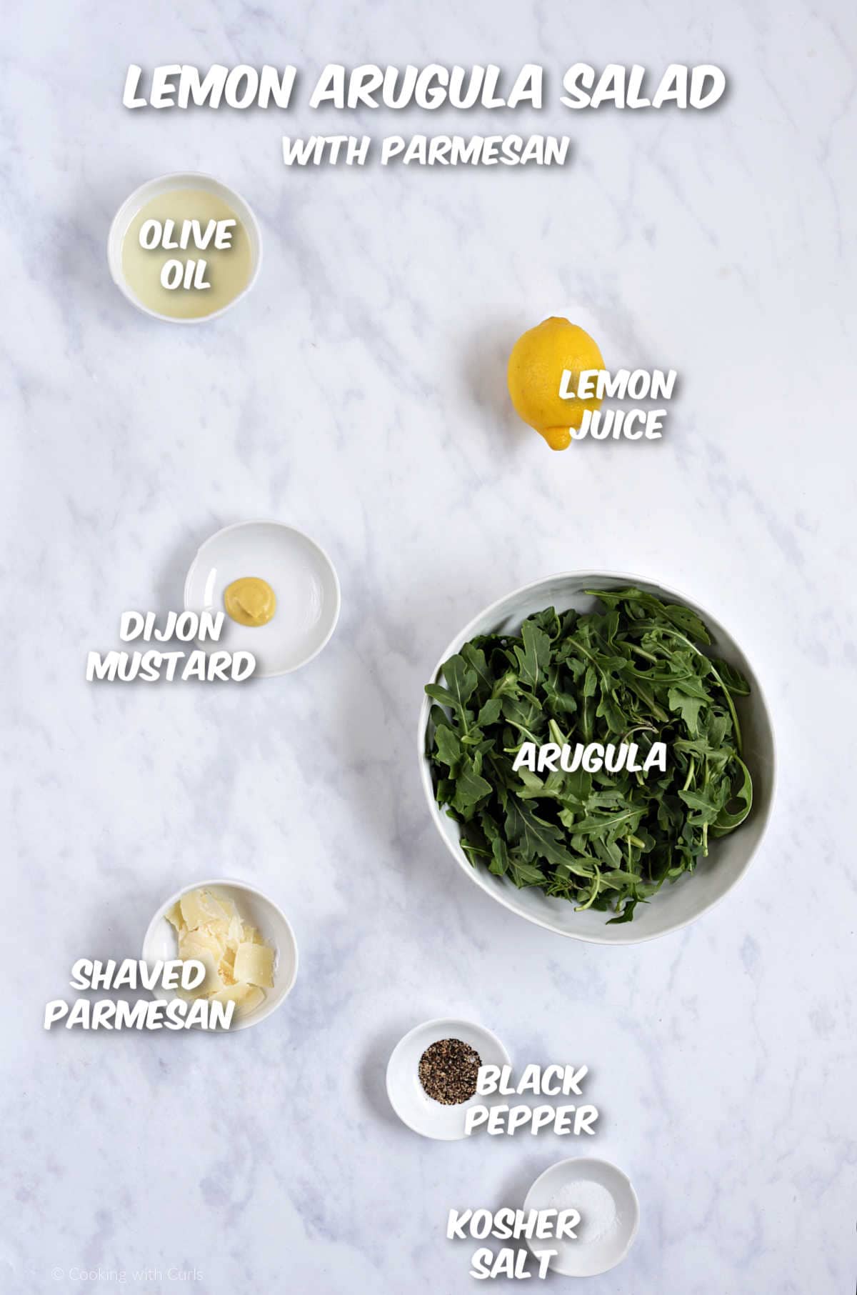 Ingredients to make an arugula salad with parmesan and lemon vinaigrette.