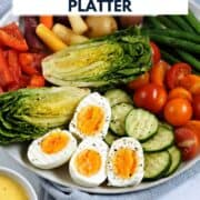 A platter of fresh vegetables and hard boiled eggs with a small bowl of aioli on the side and title graphic across the top.