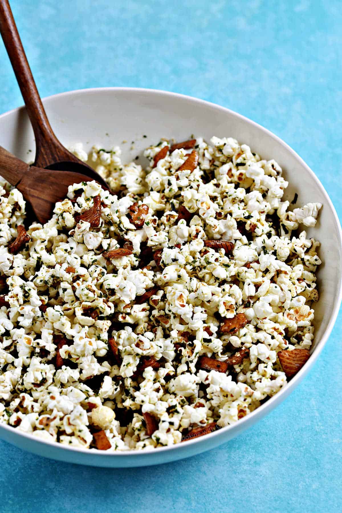 Hurricane popcorn in a large bowl with wooden spoons for serving.