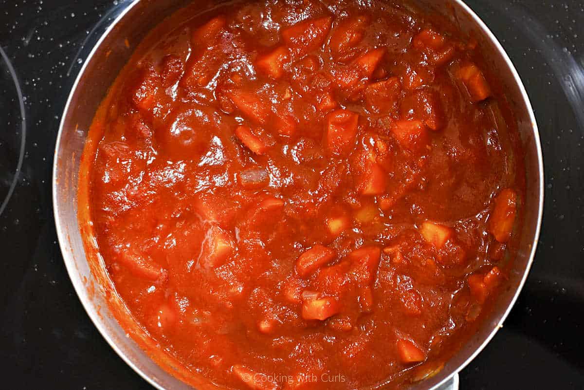 Barbecue sauce simmering in a saucepan.