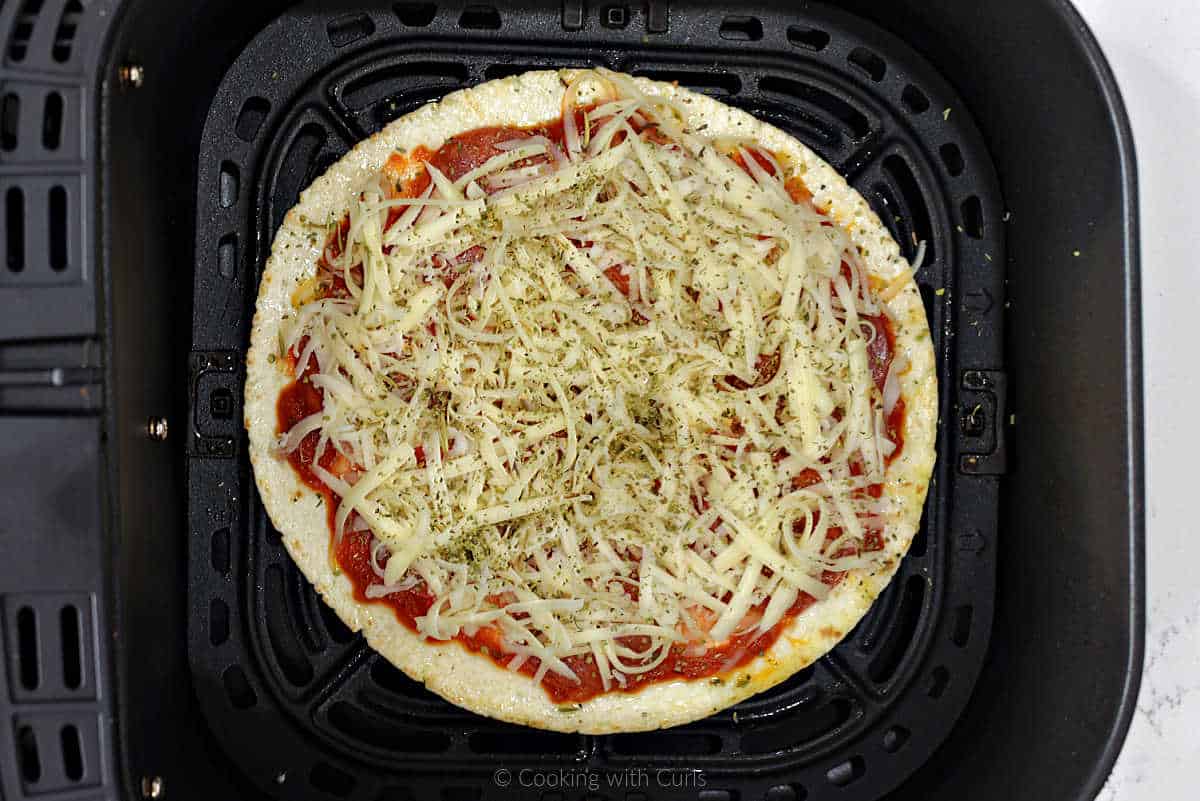 Tortilla pizza with shredded mozzarella cheese and Italian seasoning.