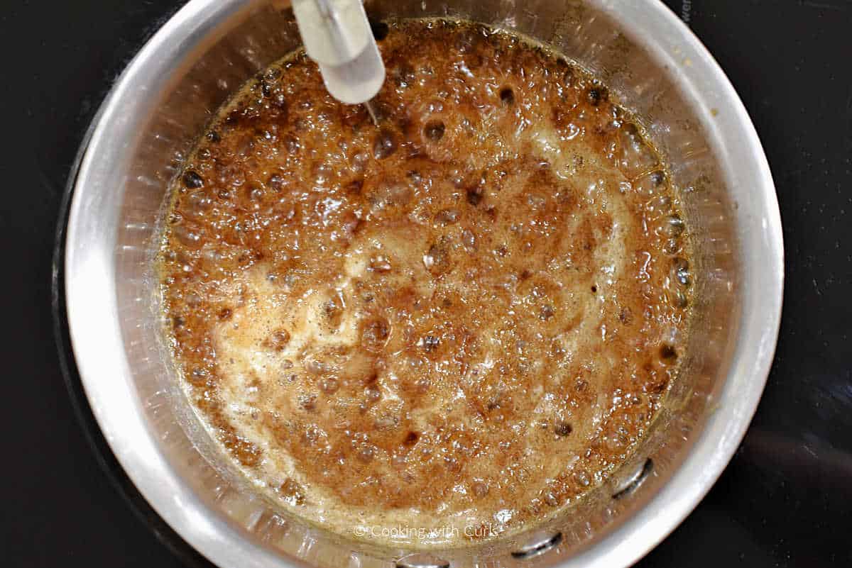 Boiling sticky bun caramel in saucepan.