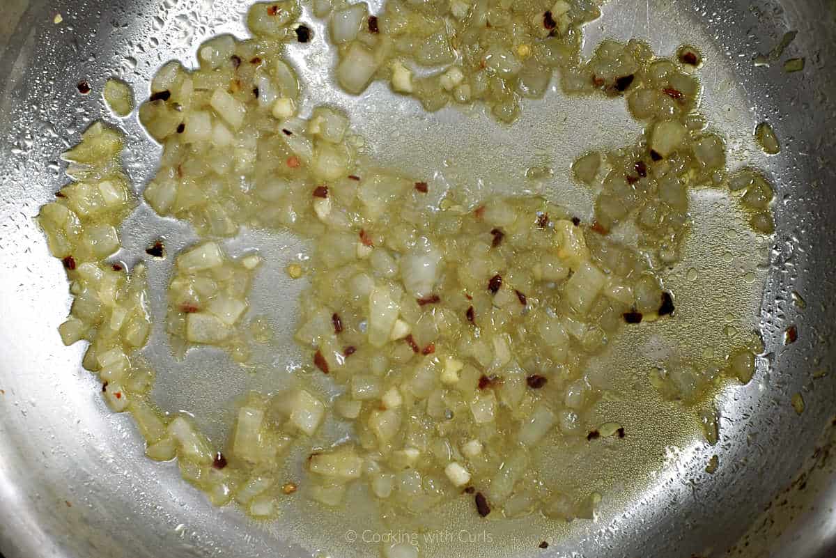 Diced onion, garlic, pepper flakes and white wine in a skillet.