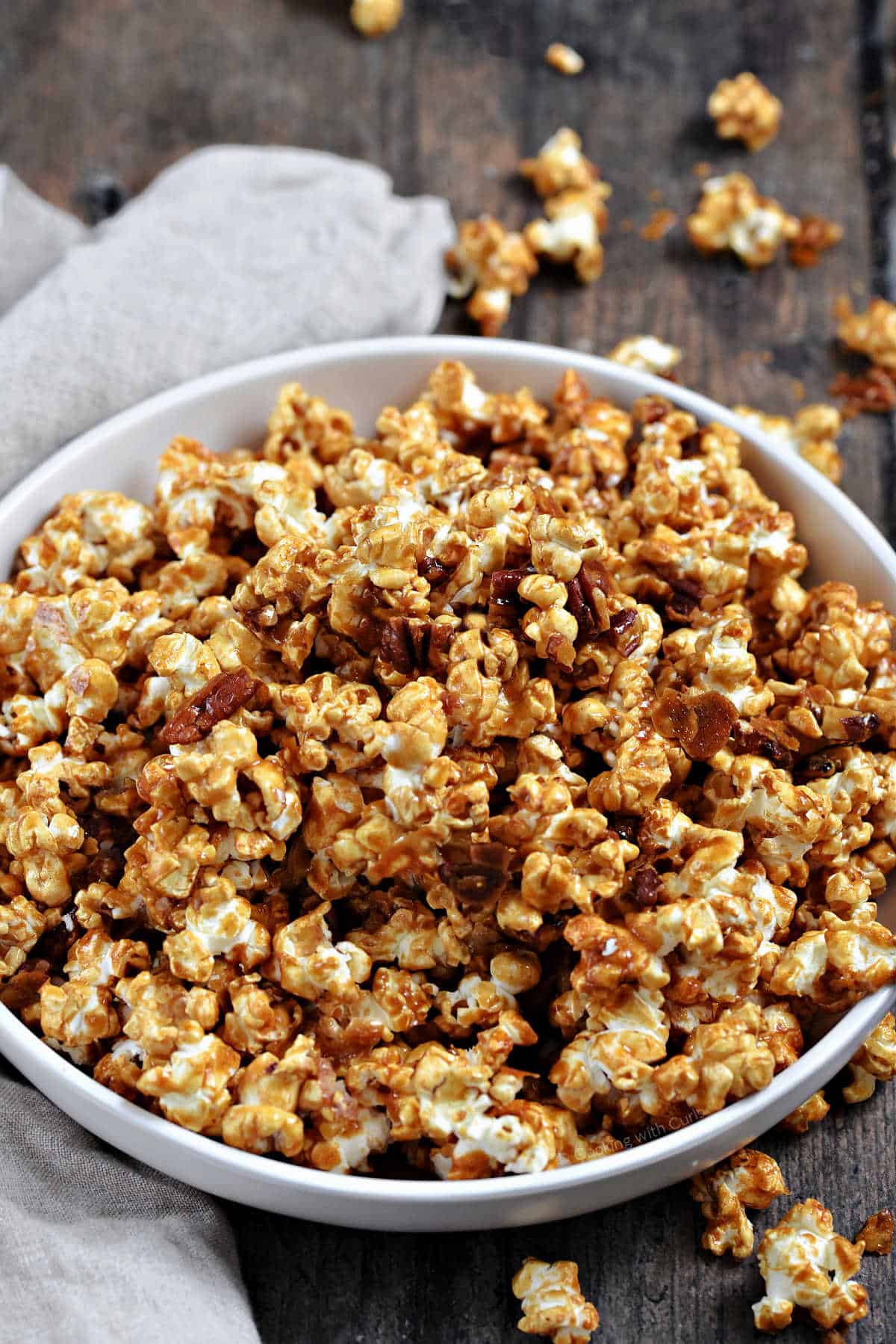 Caramel and pecan coated popcorn in a serving bowl.