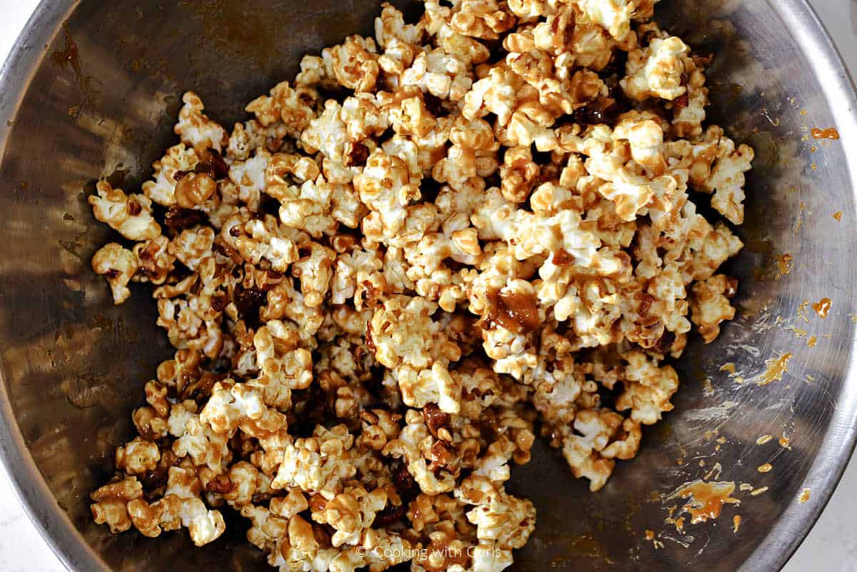 Popcorn tossed with melted caramel in a large bowl.