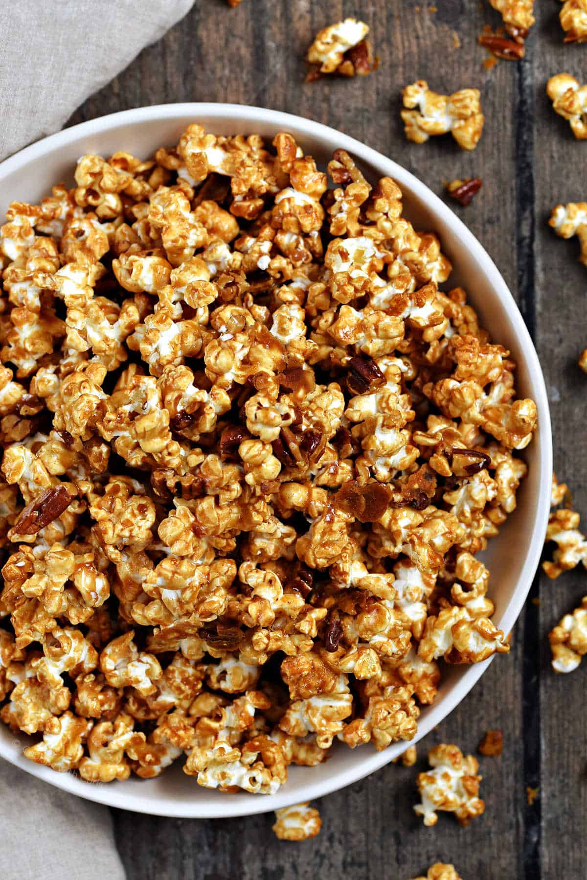 Caramel popcorn overflowing a serving bowl.