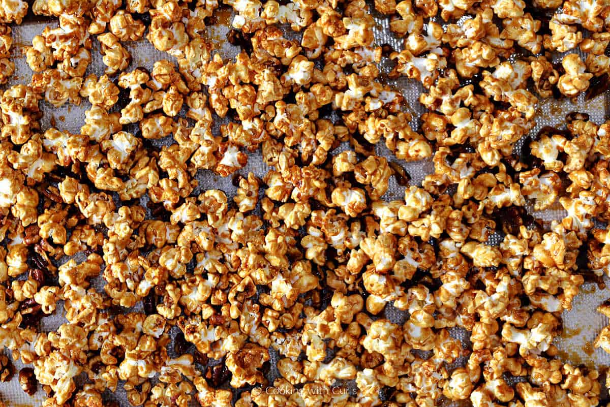 Sticky bun popcorn baked on baking sheet.