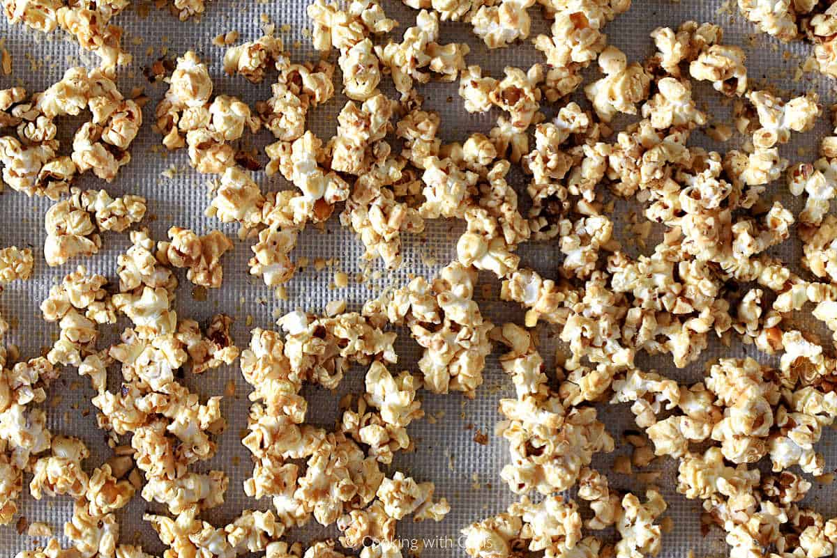 Baked baklava popcorn on a silicone lined baking sheet.