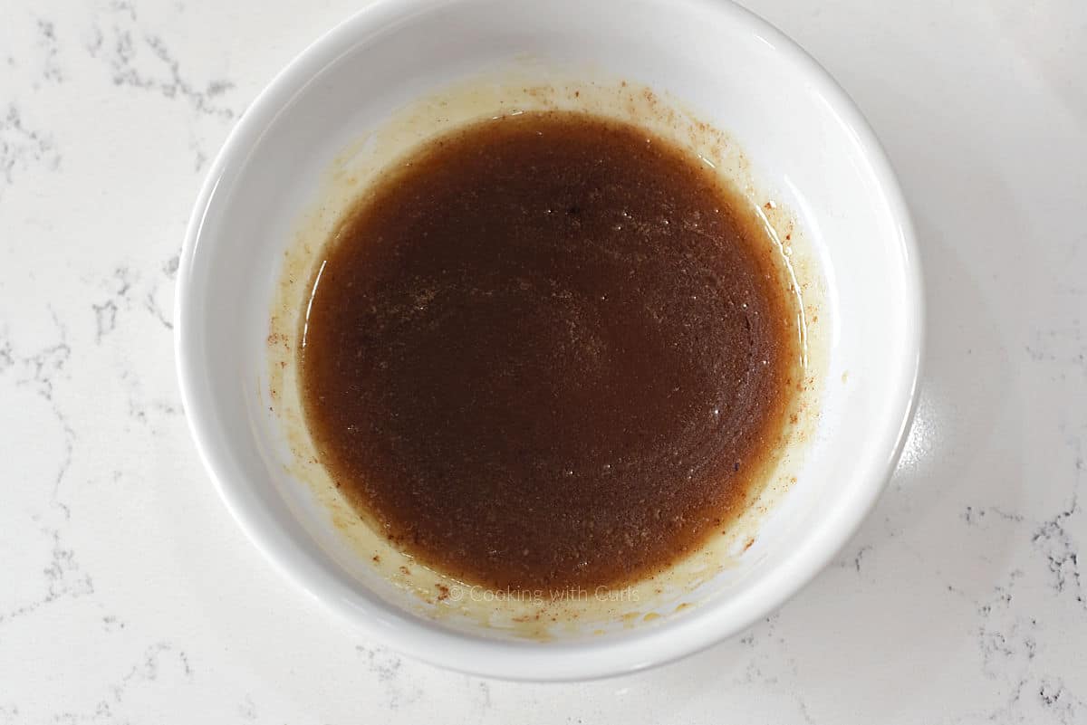 Honey, butter, cinnamon, and extracts in a small bowl.