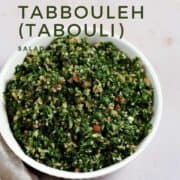 Fresh parsley, bulgar wheat, tomato, and cucumber chopped up and mixed in a bowl with title graphic across the top.