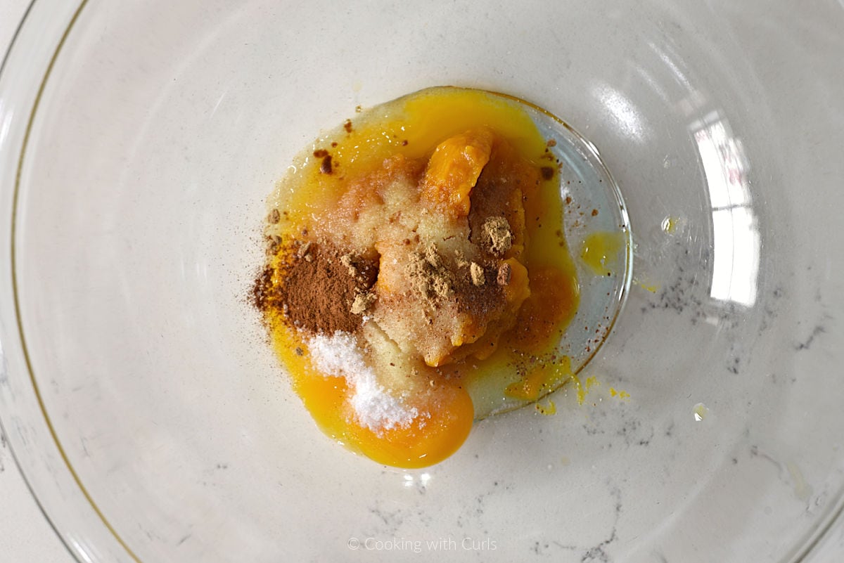 Beaten egg, pumpkin puree, sugar, and spices in mixing bowl.