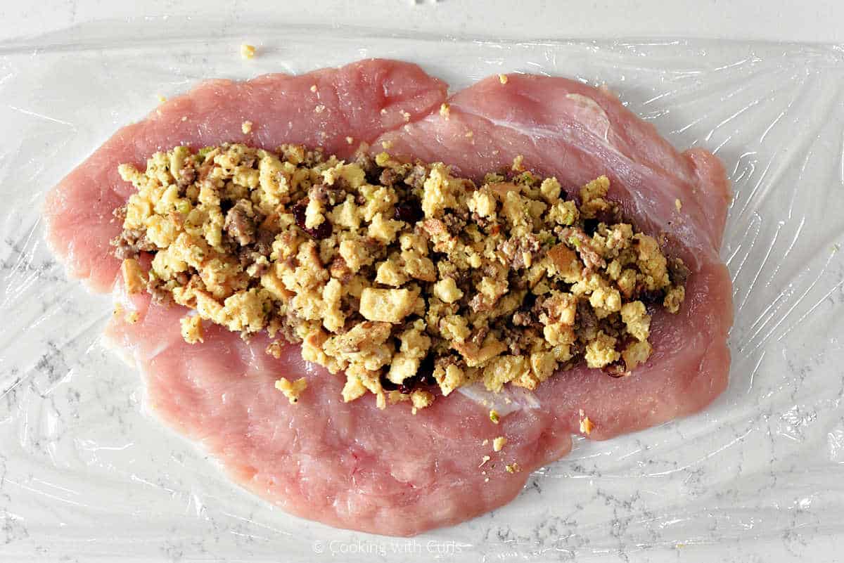 Flattened turkey breast with stuffing spread across the center.