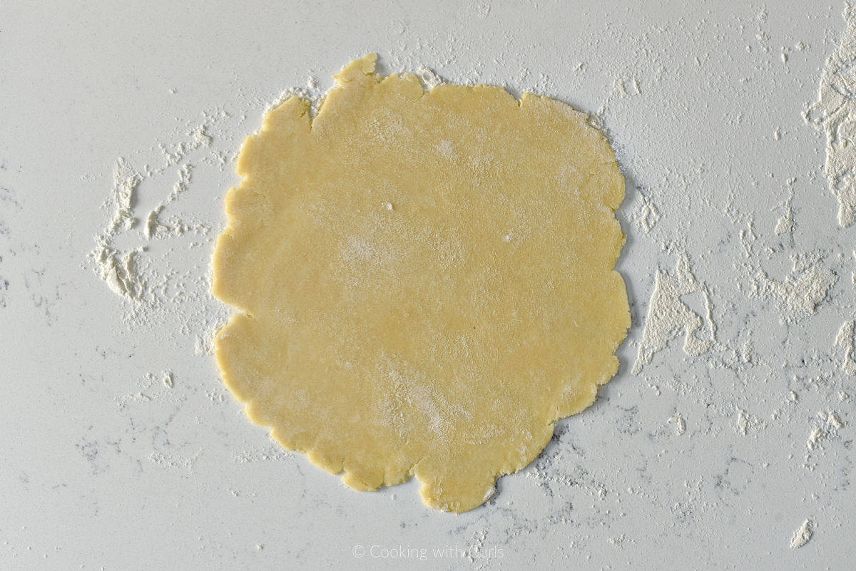 Pie crust rolled out on floured surface.