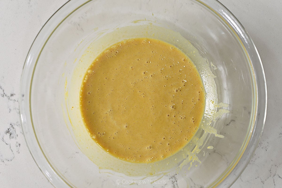 Pumpkin pie filling mixed in glass bowl.