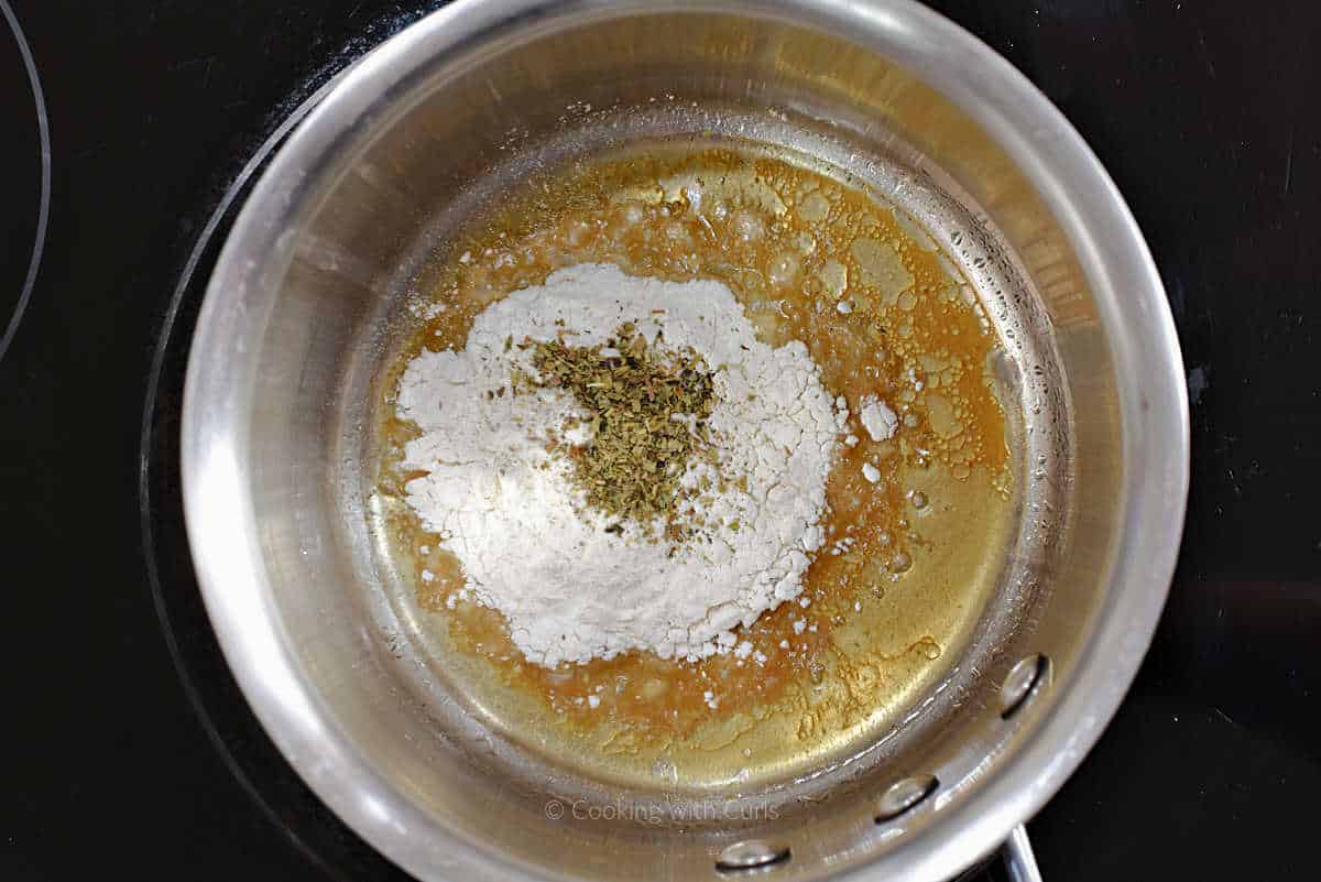 Turkey juices, flour, and herbs in saucepan.