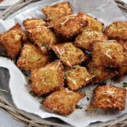 Crispy air fryer ravioli on a serving platter.