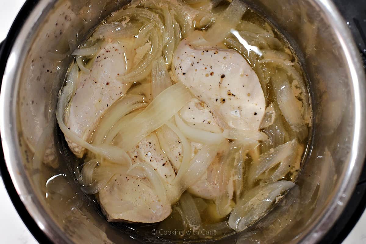 Chicken breasts and onion slices cooked in chicken broth.