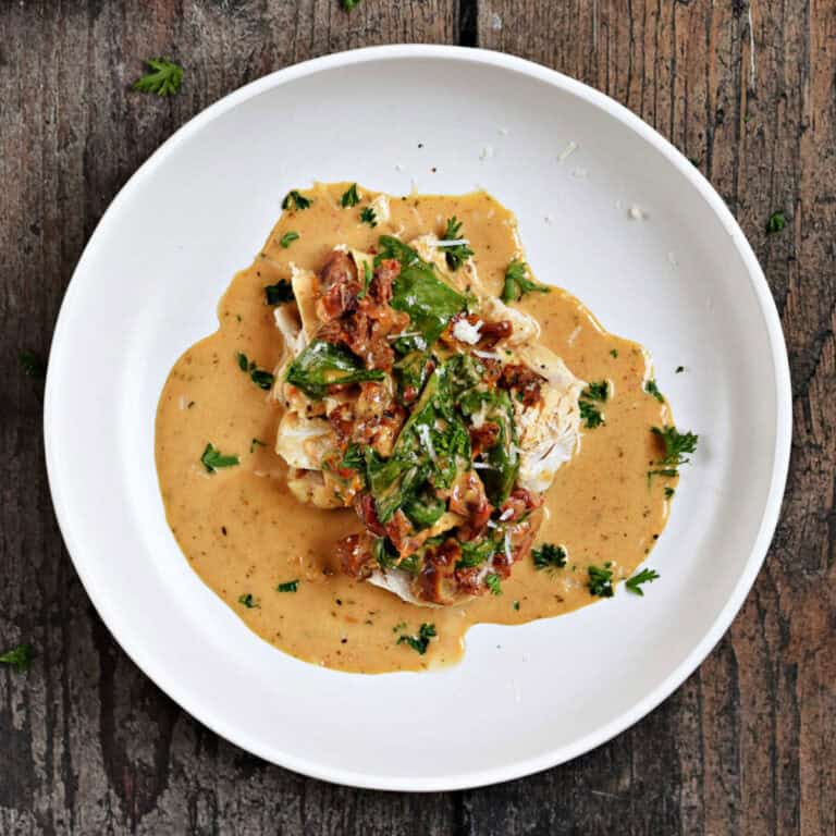 Chicken breast topped with sun-dried tomatoes, spinach, and creamy sauce.